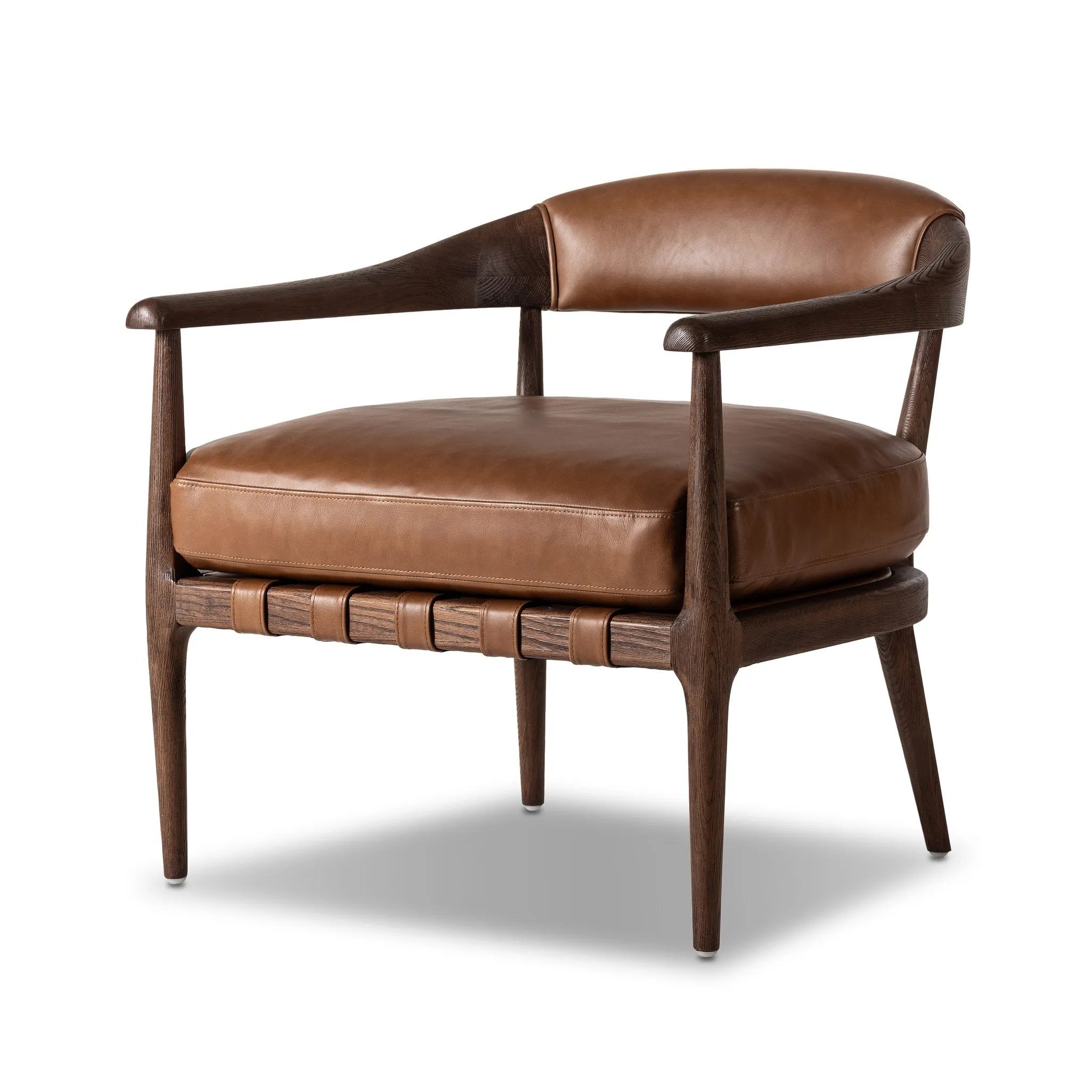 Featuring Dane Sonoma Chestnut Chair by Four Hands at Amethyst Home. Safari styling is brought to modern speed on this vintage-inspired chair. Its solid wood frame features a webbed seating structure that brings a sink-in feel to the entire piece. The upholstered back, strap details and loose cushion are finished in carbon neutral, vegetable-tanned leather . Amethyst Home provides interior design, new home construction design consulting, vintage area rugs, and lighting in the Calabasas metro area.
