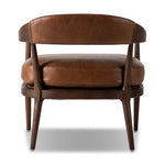 Featuring Dane Sonoma Chestnut Chair by Four Hands at Amethyst Home. Safari styling is brought to modern speed on this vintage-inspired chair. Its solid wood frame features a webbed seating structure that brings a sink-in feel to the entire piece. The upholstered back, strap details and loose cushion are finished in carbon neutral, vegetable-tanned leather . Amethyst Home provides interior design, new home construction design consulting, vintage area rugs, and lighting in the Nashville metro area.