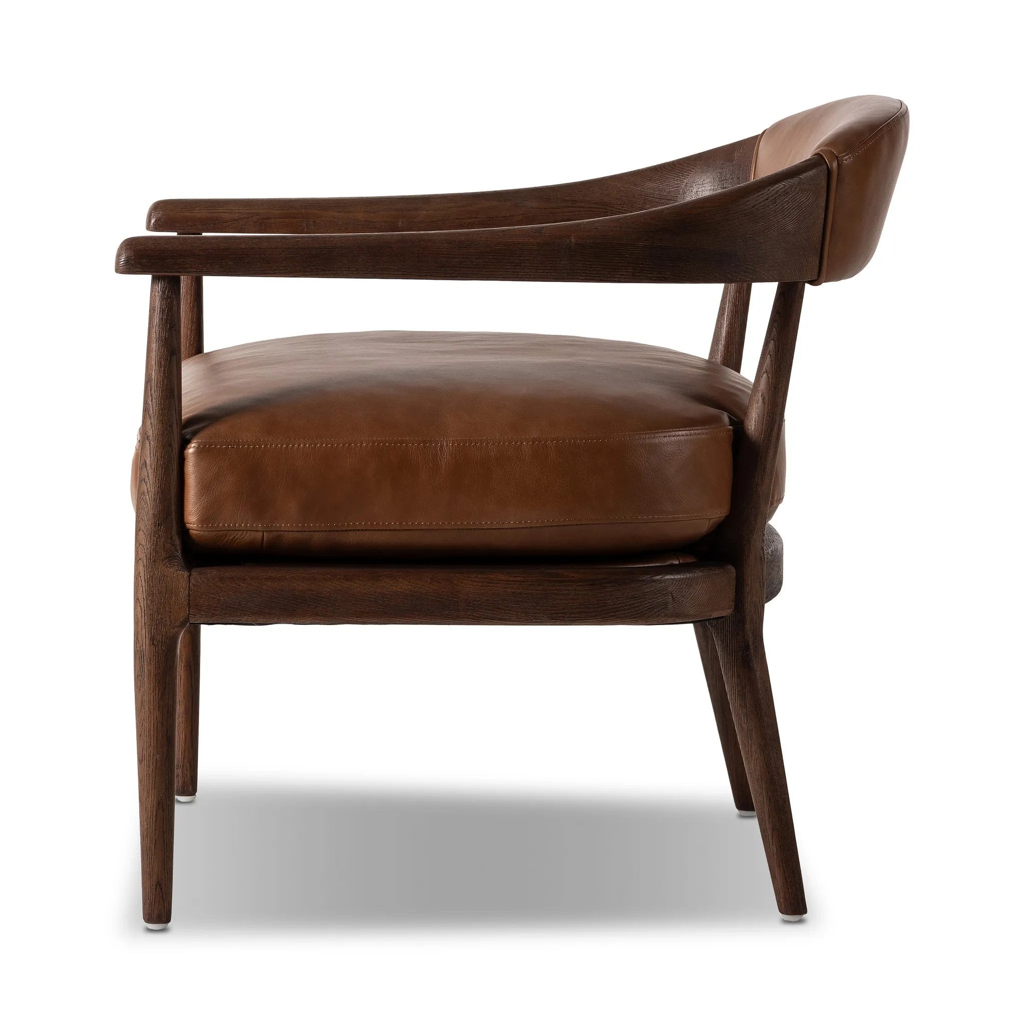 Featuring Dane Sonoma Chestnut Chair by Four Hands at Amethyst Home. Safari styling is brought to modern speed on this vintage-inspired chair. Its solid wood frame features a webbed seating structure that brings a sink-in feel to the entire piece. The upholstered back, strap details and loose cushion are finished in carbon neutral, vegetable-tanned leat. Amethyst Home provides interior design, new home construction design consulting, vintage area rugs, and lighting in the Newport Beach metro area.