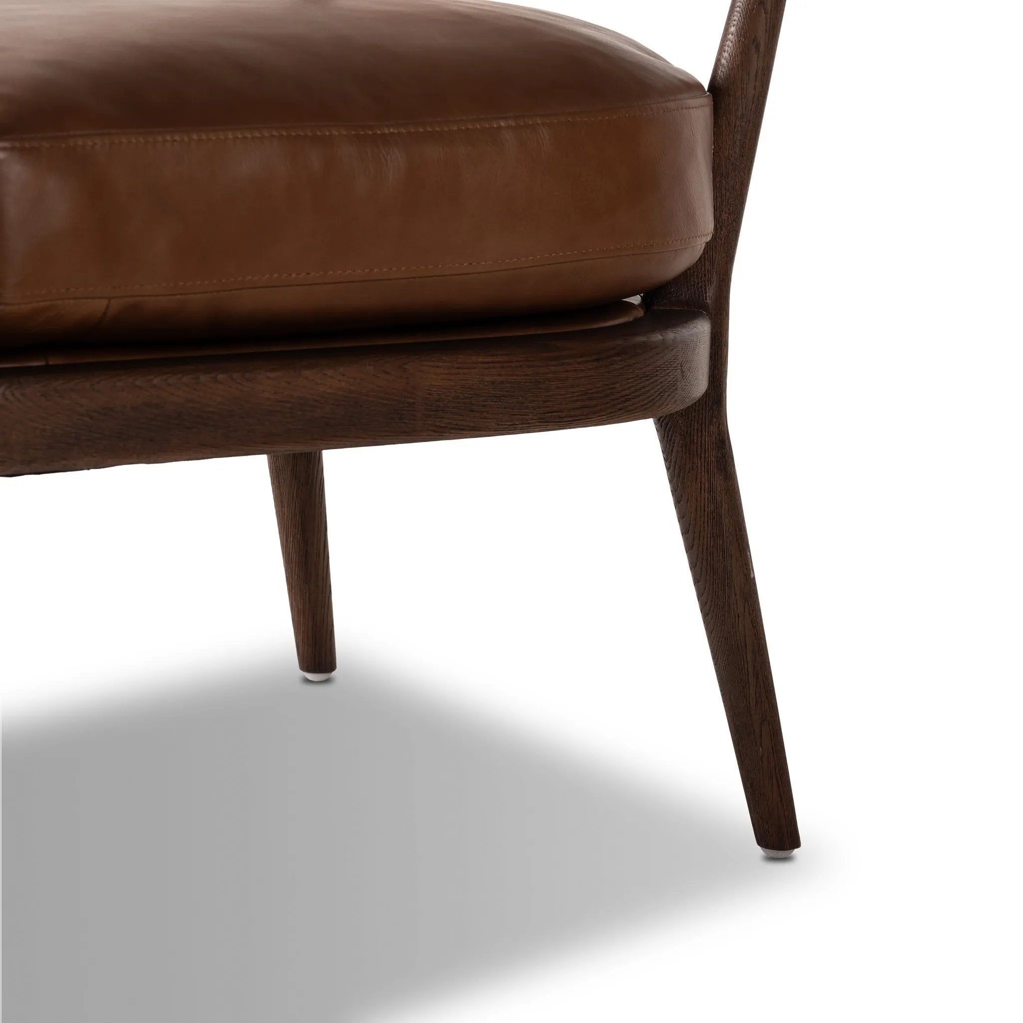 Featuring Dane Sonoma Chestnut Chair by Four Hands at Amethyst Home. Safari styling is brought to modern speed on this vintage-inspired chair. Its solid wood frame features a webbed seating structure that brings a sink-in feel to the entire piece. The upholstered back, strap details and loose cushion are finished in carbon neutral, vegetable-tanned leather p. Amethyst Home provides interior design, new home construction design consulting, vintage area rugs, and lighting in the Portland metro area.