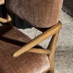 Pastoral inspiration defines a thoughtfully designed dining chair of toasted oak, while soft earthen upholstery covers a comfortable seat and back Amethyst Home provides interior design, new home construction design consulting, vintage area rugs, and lighting in the Charlotte metro area.