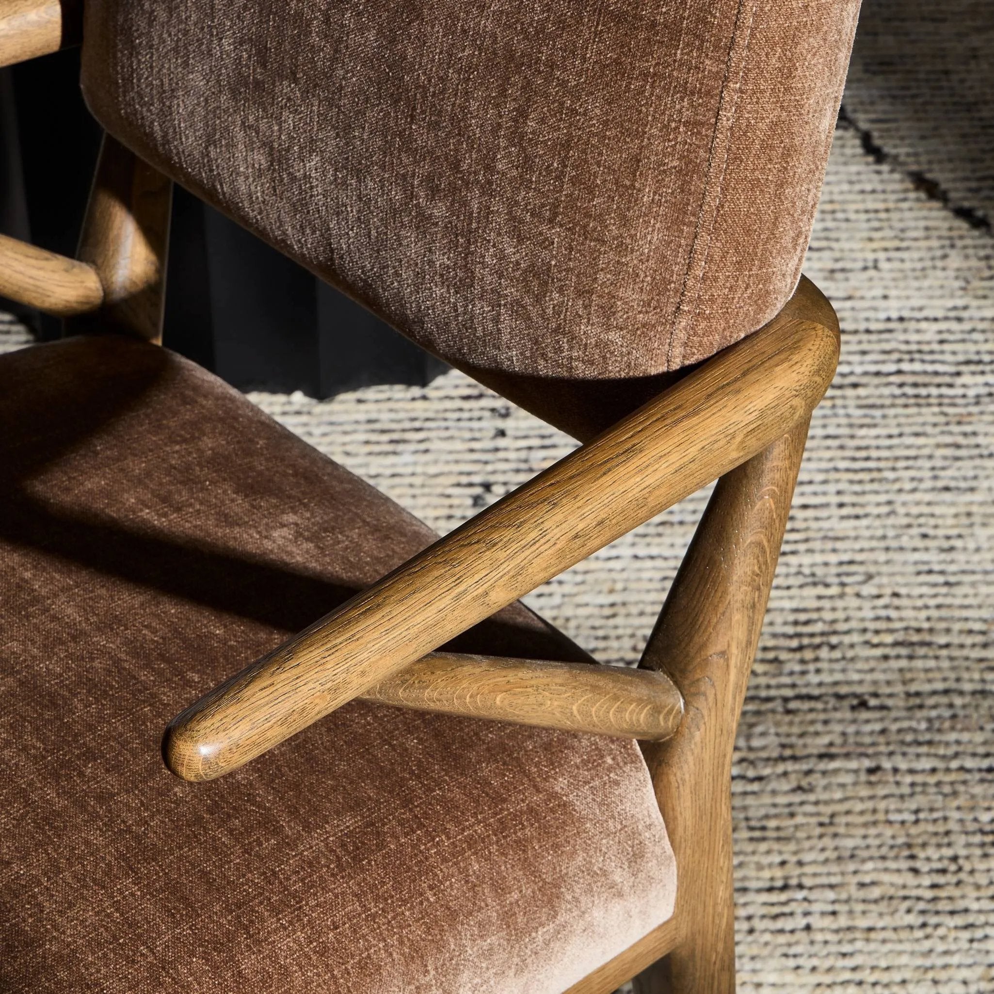 Pastoral inspiration defines a thoughtfully designed dining chair of toasted oak, while soft earthen upholstery covers a comfortable seat and back Amethyst Home provides interior design, new home construction design consulting, vintage area rugs, and lighting in the Charlotte metro area.
