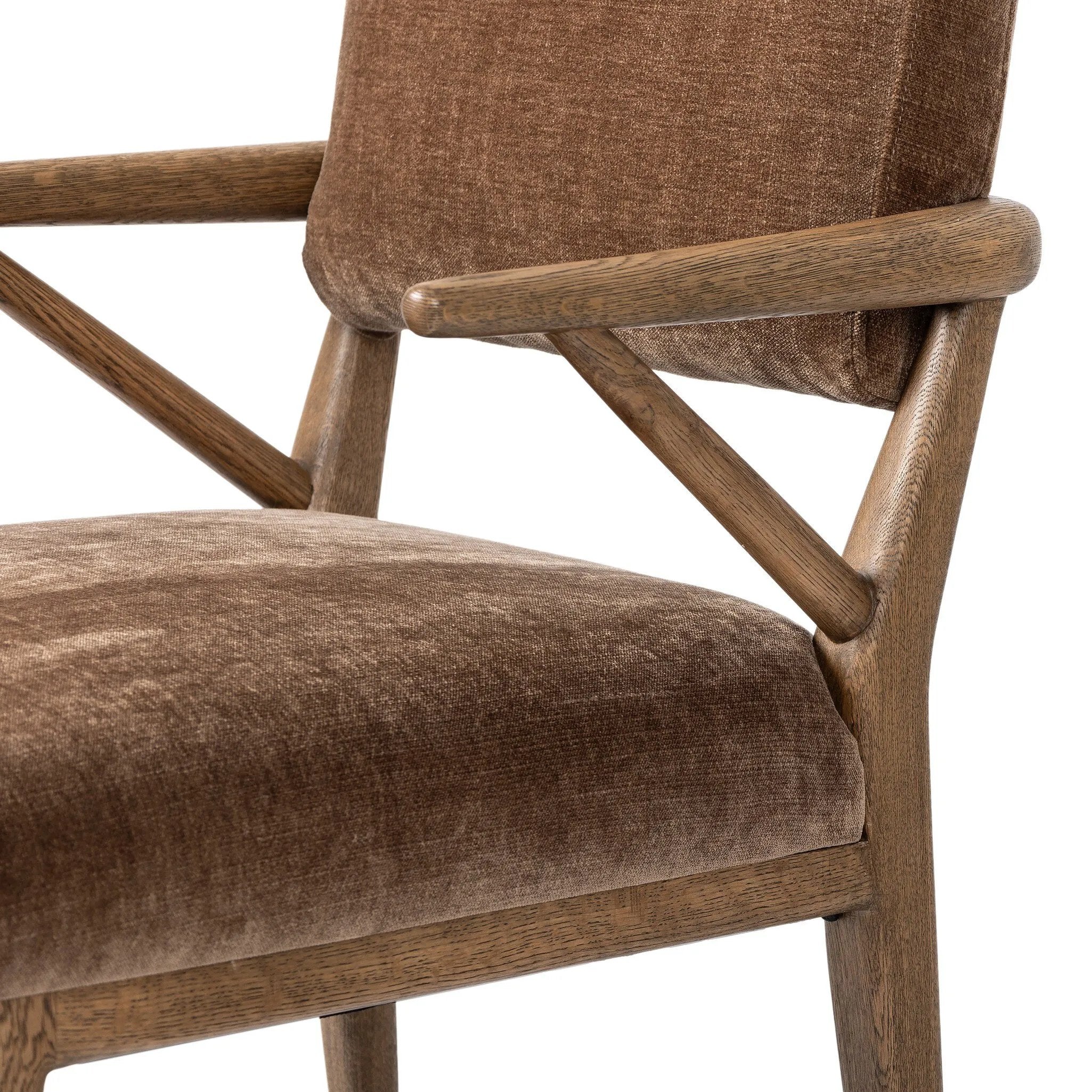 Pastoral inspiration defines a thoughtfully designed dining chair of toasted oak, while soft earthen upholstery covers a comfortable seat and back Amethyst Home provides interior design, new home construction design consulting, vintage area rugs, and lighting in the Des Moines metro area.