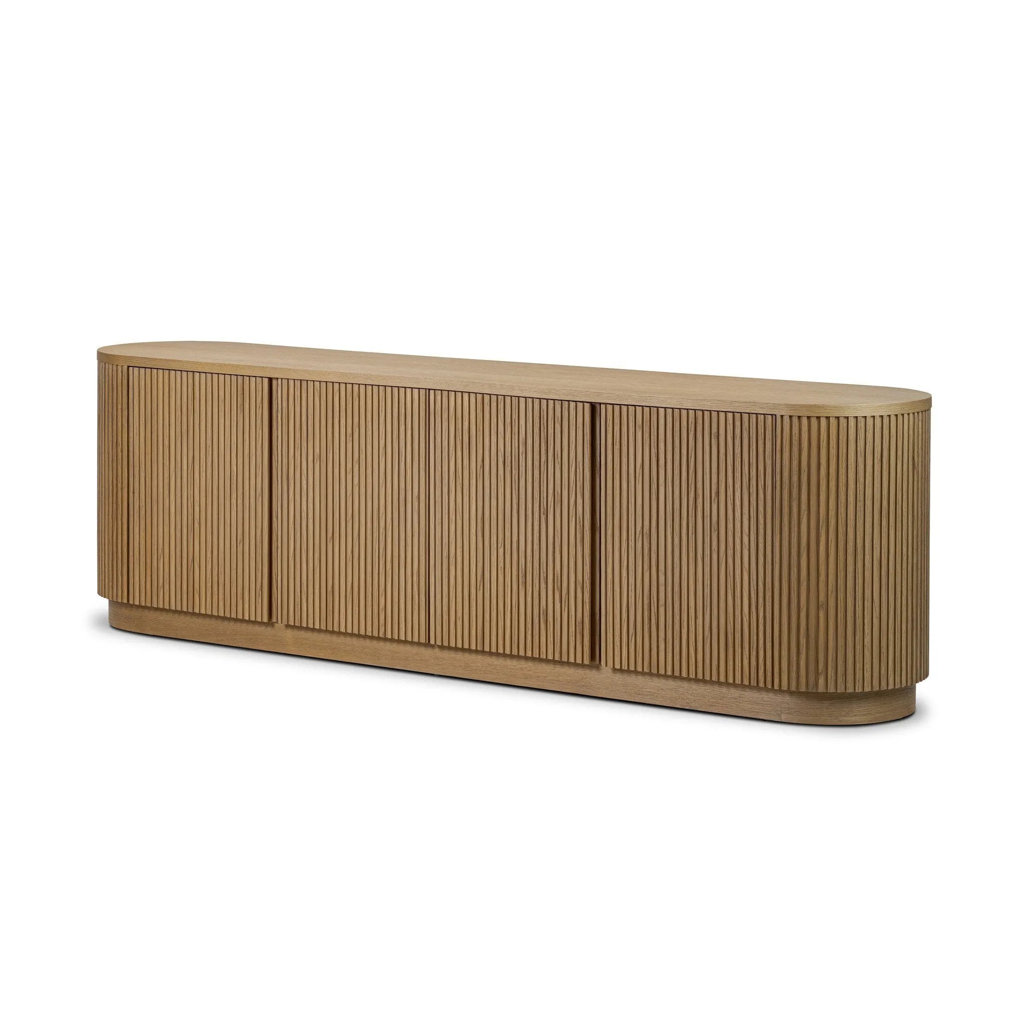 Crafted from desert oak solids and veneers with a plinth-style base, rounded sides and linear reeding, this sideboard exudes midcentury vibes.  Fully finished interior and shelves for quality detailing inside and out Amethyst Home provides interior design, new home construction design consulting, vintage area rugs, and lighting in the Alpharetta metro area.