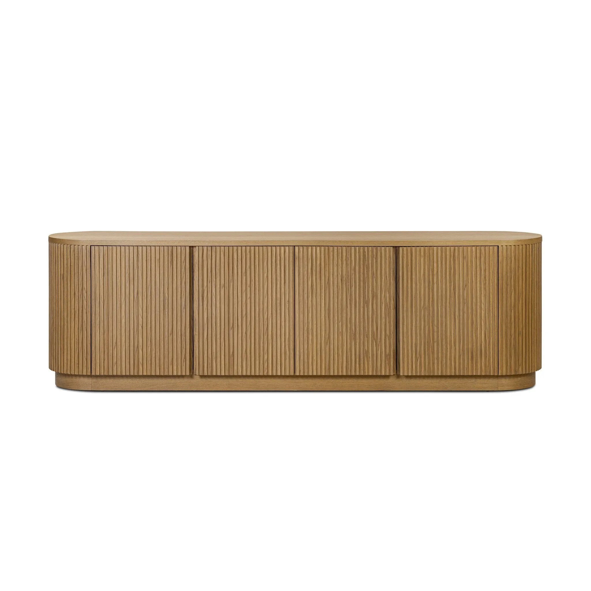 Crafted from desert oak solids and veneers with a plinth-style base, rounded sides and linear reeding, this sideboard exudes midcentury vibes.  Fully finished interior and shelves for quality detailing inside and out Amethyst Home provides interior design, new home construction design consulting, vintage area rugs, and lighting in the Dallas metro area.