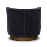 The continuous form of this swivel chair creates a sleek look that elevates everyday seating. Upholstered in navy wool blend, its sleek design is complemented by a 360-degree swivel and pedestal base of solid parawood for a mixed media moment Amethyst Home provides interior design, new home construction design consulting, vintage area rugs, and lighting in the Des Moines metro area.