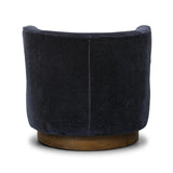 The continuous form of this swivel chair creates a sleek look that elevates everyday seating. Upholstered in navy wool blend, its sleek design is complemented by a 360-degree swivel and pedestal base of solid parawood for a mixed media moment Amethyst Home provides interior design, new home construction design consulting, vintage area rugs, and lighting in the Des Moines metro area.