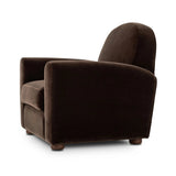 The popular Art Deco club chair makes a comeback. With a prominent curved top, deep seat with a loose cushion, and armrests designed for true relaxation, the armchair invites you to sit back and take it all in. Upholstered in rich chocolate upholstery.As fans of luxe materials at Amethyst, we love the nature inspired Draper Chair - Monte Chocolate. Amethyst Home provides interior design, new home construction design consulting, vintage area rugs, and lighting in the Los Angeles metro area.