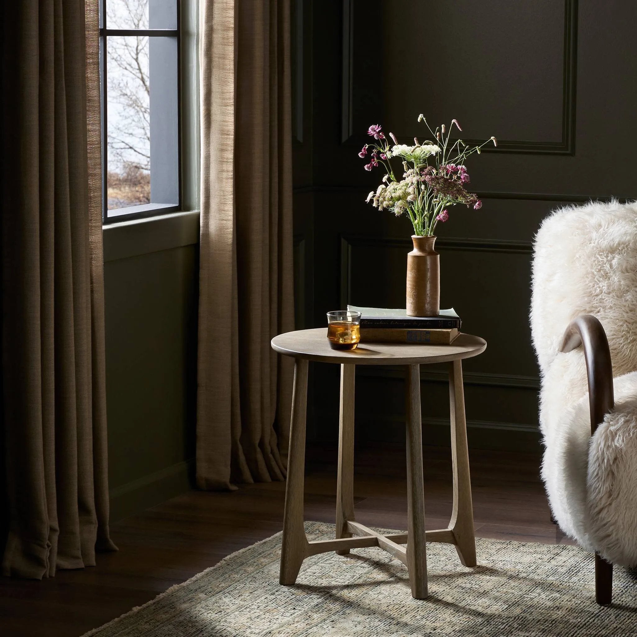 A simple oak table with a warm, light finish features subtle leg details for an artisan touch. Perfectly sized to keep your favorite book or drink within reach, in any space or style Amethyst Home provides interior design, new home construction design consulting, vintage area rugs, and lighting in the Los Angeles metro area.