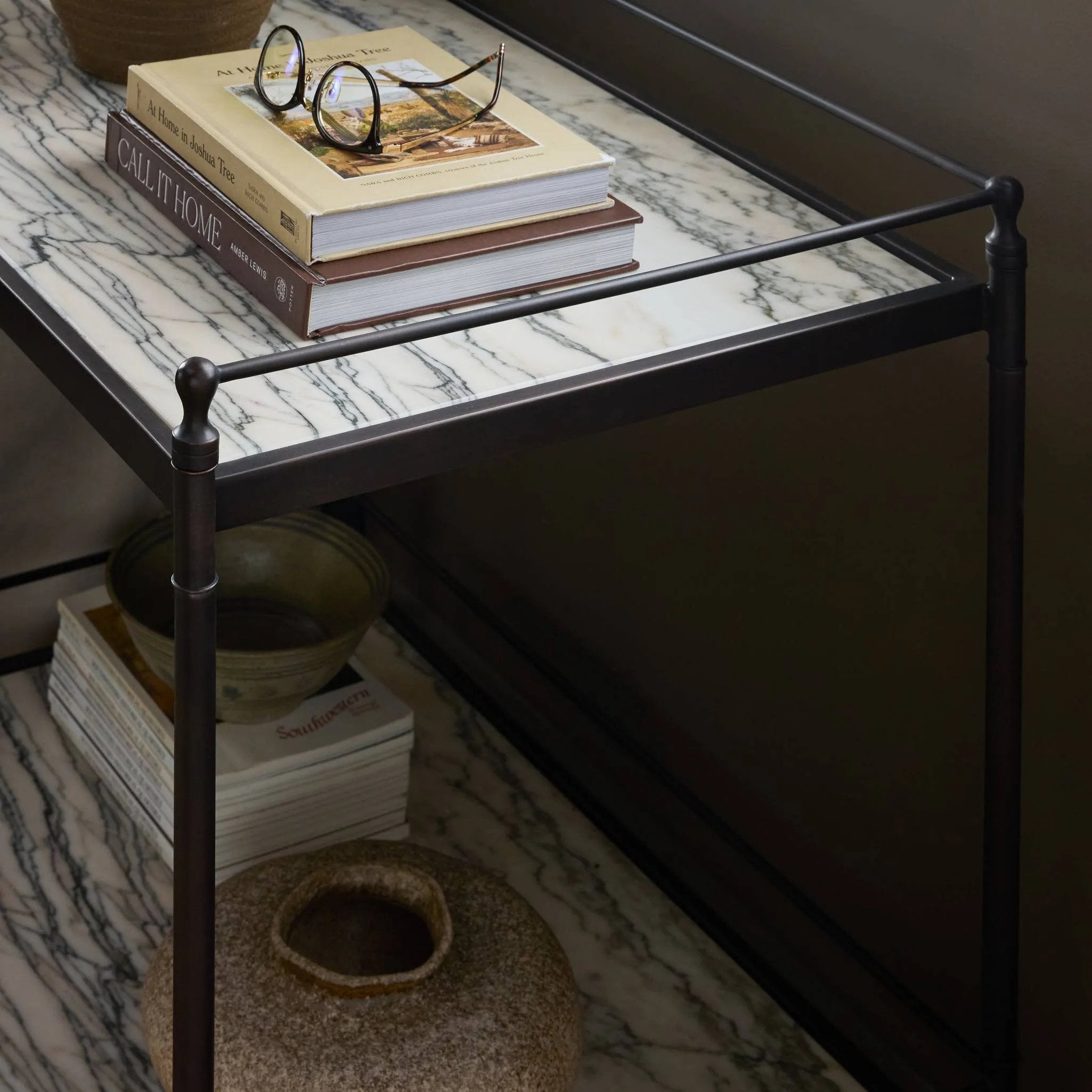 Bring a touch of heritage charm to your bedroom with this two-tier metal nightstand. An aged rust finish complements solid marble shelves with stripe-like veining, finished out with turned legs and gallery edging Amethyst Home provides interior design, new home construction design consulting, vintage area rugs, and lighting in the Tampa metro area.