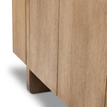 A clean-styled media console made from warm, grain-rich oak. Six doors feature subtle finger grooves for easy open. Gentle curves soften up the look, while a floating design keeps things feeling light and fresh. Inside, generous shelving awaits storage of media and more. Amethyst Home provides interior design, new home construction design consulting, vintage area rugs, and lighting in the Austin metro area.