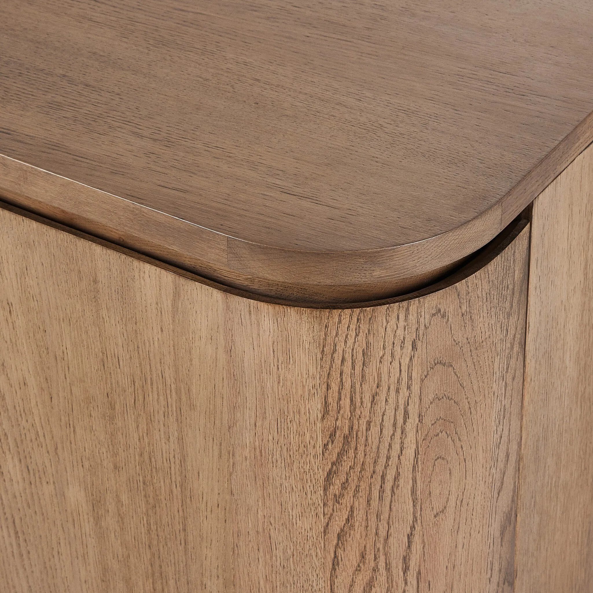 A clean-styled media console made from warm, grain-rich oak. Six doors feature subtle finger grooves for easy open. Gentle curves soften up the look, while a floating design keeps things feeling light and fresh. Inside, generous shelving awaits storage of media and more. Amethyst Home provides interior design, new home construction design consulting, vintage area rugs, and lighting in the San Diego metro area.