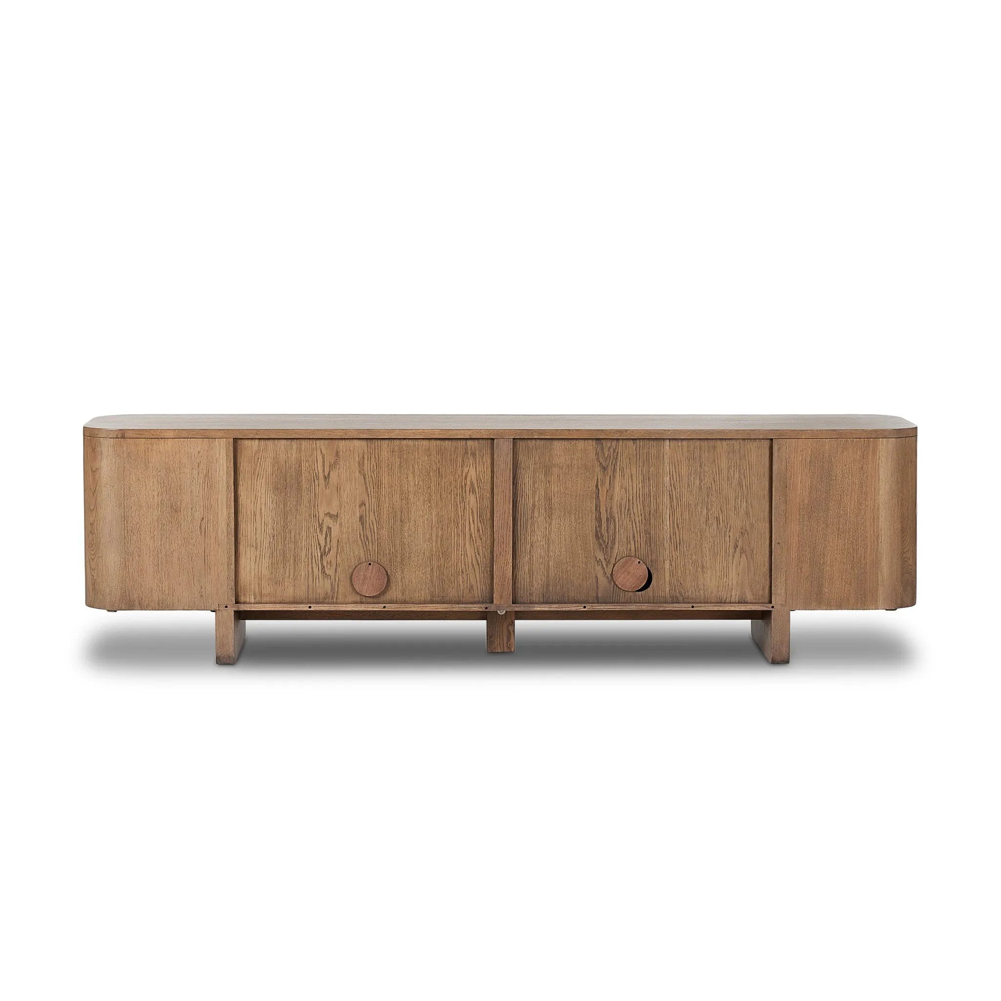 A clean-styled media console made from warm, grain-rich oak. Six doors feature subtle finger grooves for easy open. Gentle curves soften up the look, while a floating design keeps things feeling light and fresh. Inside, generous shelving awaits storage of media and more. Amethyst Home provides interior design, new home construction design consulting, vintage area rugs, and lighting in the Scottsdale metro area.