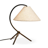 A dramatically curved silhouette and tripod base of matte black metal pair with a flax linen shade for a shapely, minimalist feel Amethyst Home provides interior design, new home construction design consulting, vintage area rugs, and lighting in the Boston metro area.