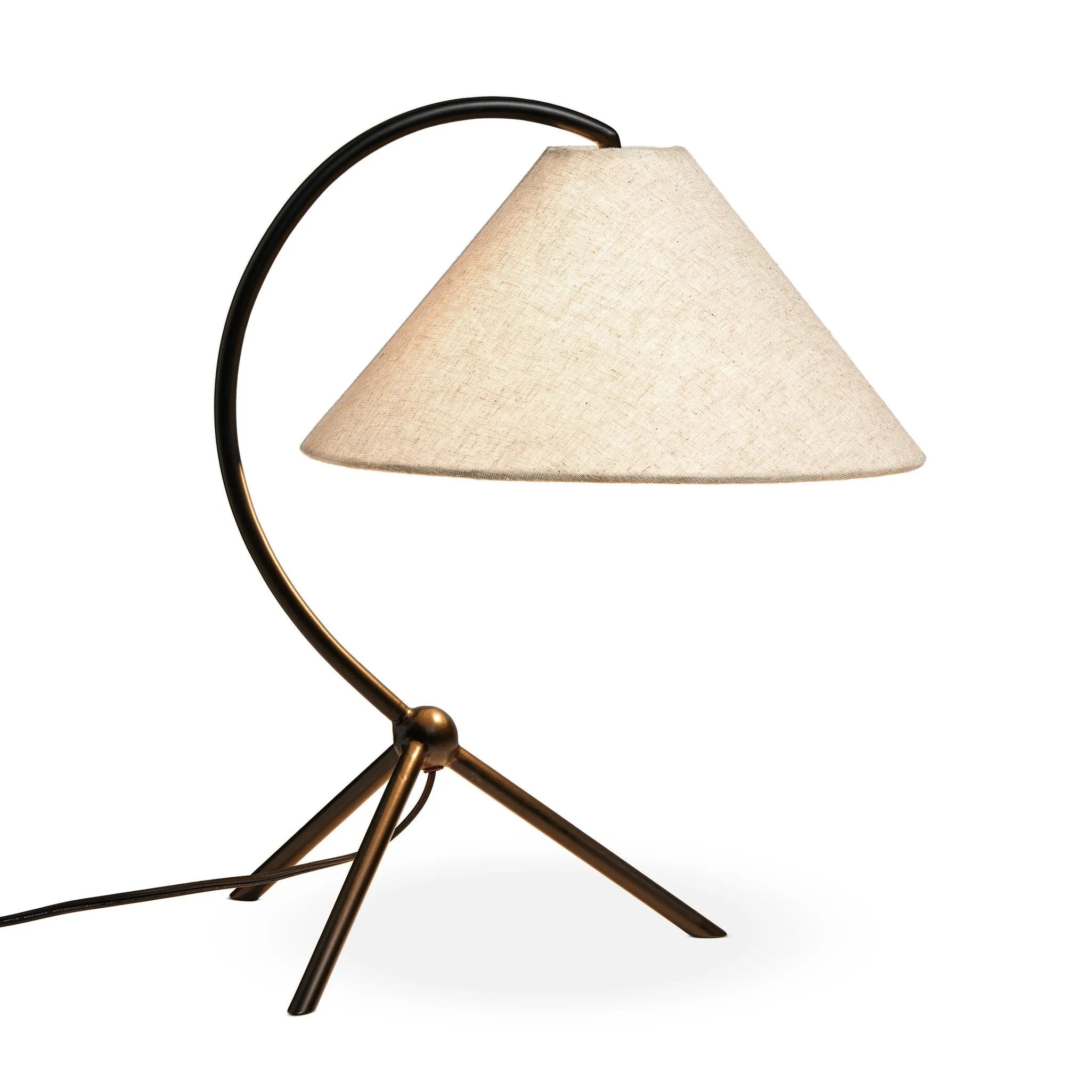 A dramatically curved silhouette and tripod base of matte black metal pair with a flax linen shade for a shapely, minimalist feel Amethyst Home provides interior design, new home construction design consulting, vintage area rugs, and lighting in the Boston metro area.