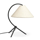 A dramatically curved silhouette and tripod base of matte black metal pair with a flax linen shade for a shapely, minimalist feel Amethyst Home provides interior design, new home construction design consulting, vintage area rugs, and lighting in the Charlotte metro area.