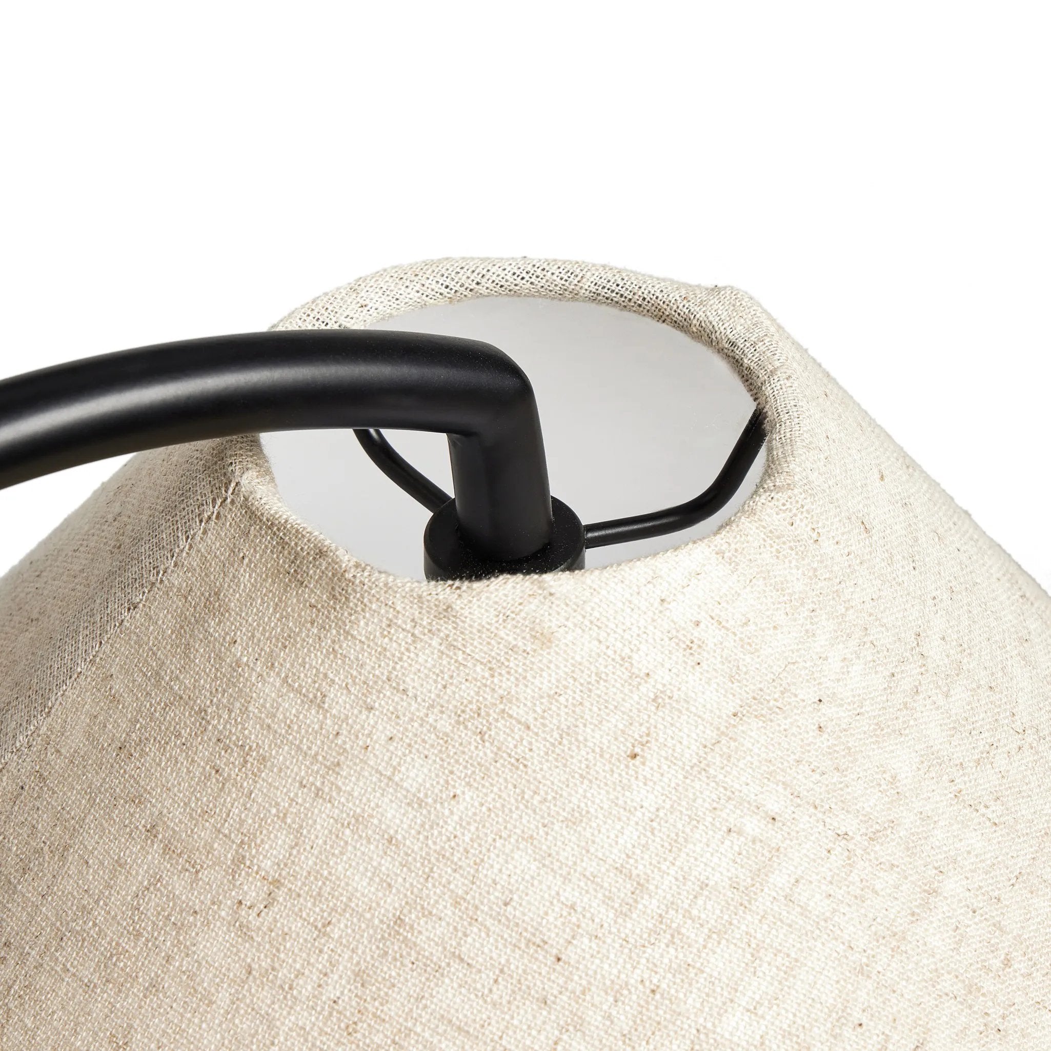A dramatically curved silhouette and tripod base of matte black metal pair with a flax linen shade for a shapely, minimalist feel Amethyst Home provides interior design, new home construction design consulting, vintage area rugs, and lighting in the Omaha metro area.