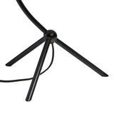 A dramatically curved silhouette and tripod base of matte black metal pair with a flax linen shade for a shapely, minimalist feel Amethyst Home provides interior design, new home construction design consulting, vintage area rugs, and lighting in the Seattle metro area.