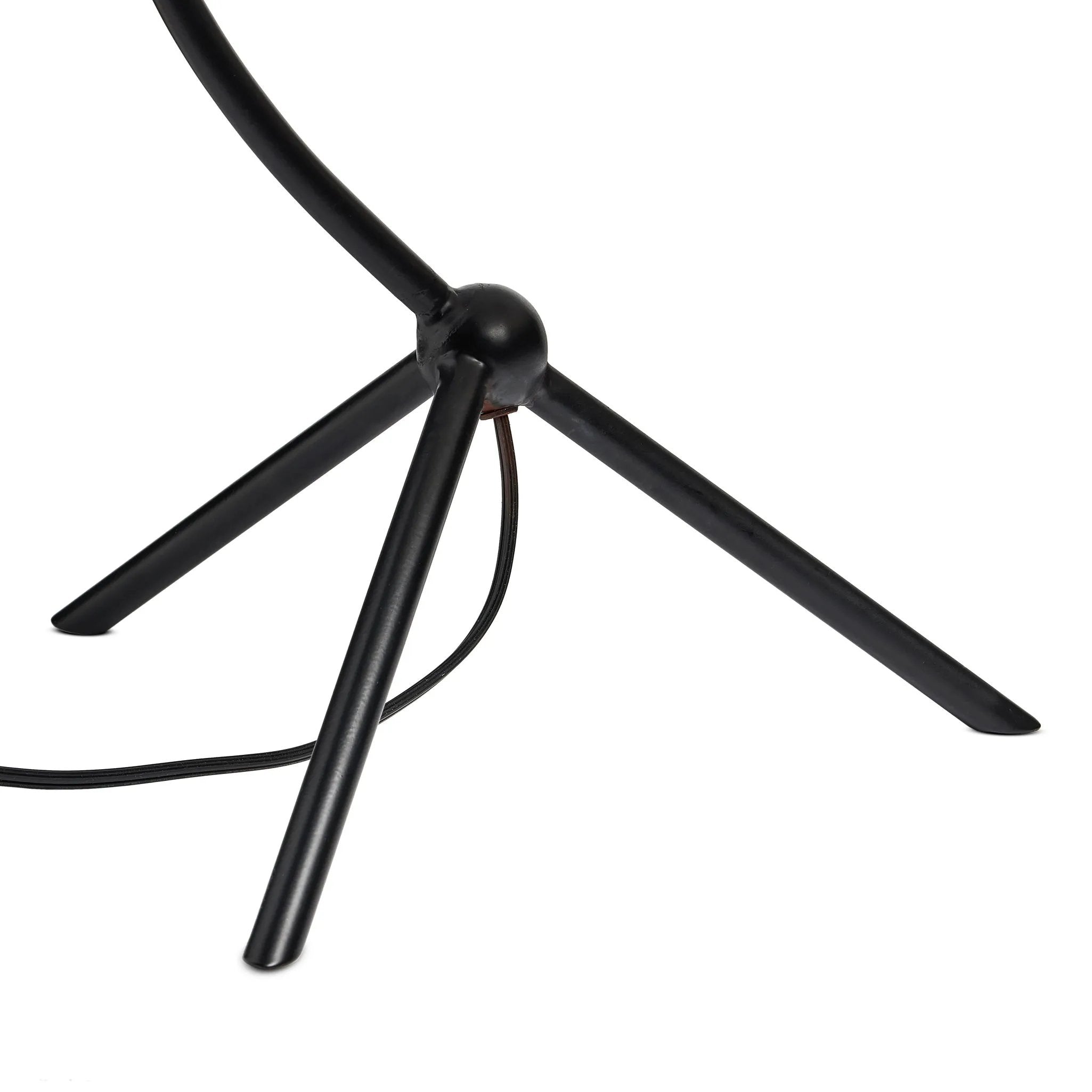 A dramatically curved silhouette and tripod base of matte black metal pair with a flax linen shade for a shapely, minimalist feel Amethyst Home provides interior design, new home construction design consulting, vintage area rugs, and lighting in the Seattle metro area.