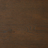 A simple shape is elevated with an X-style cradle base and pull through detailing. Made of solid oak, featuring a deep tobacco finish Amethyst Home provides interior design, new home construction design consulting, vintage area rugs, and lighting in the Laguna Beach metro area.