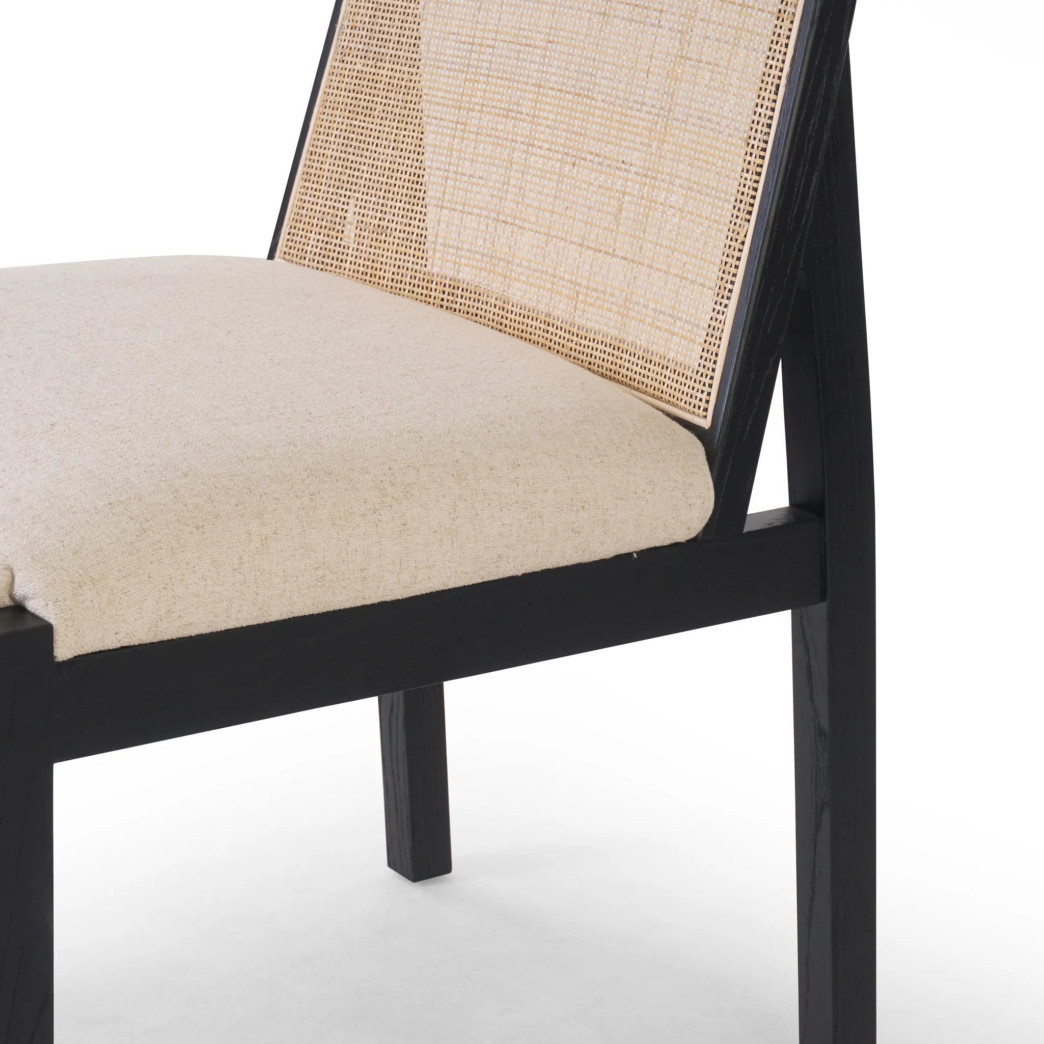 Ebony nettlewood shapes the arched, angled back of this simply shaped, armless dining chair. Natural crosshatch cane adds a light texture to complement the creamy, neutral upholstered seat. Performance fabrics are specially created to withstand spills, stains, high traffic and wear, ensuring long-term comfort and unmatched durability Amethyst Home provides interior design, new home construction design consulting, vintage area rugs, and lighting in the Miami metro area.