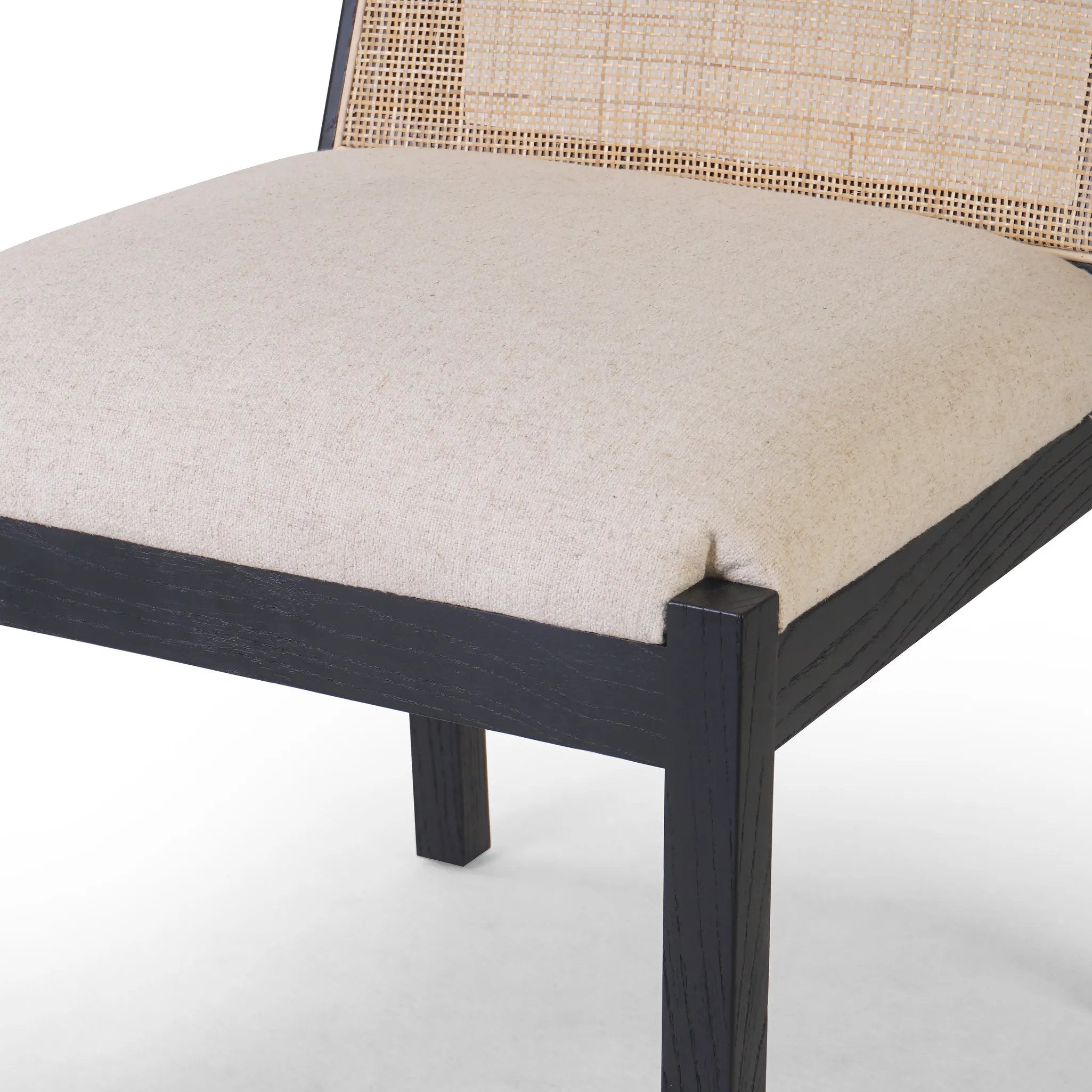 Ebony nettlewood shapes the arched, angled back of this simply shaped, armless dining chair. Natural crosshatch cane adds a light texture to complement the creamy, neutral upholstered seat. Performance fabrics are specially created to withstand spills, stains, high traffic and wear, ensuring long-term comfort and unmatched durability Amethyst Home provides interior design, new home construction design consulting, vintage area rugs, and lighting in the Seattle metro area.