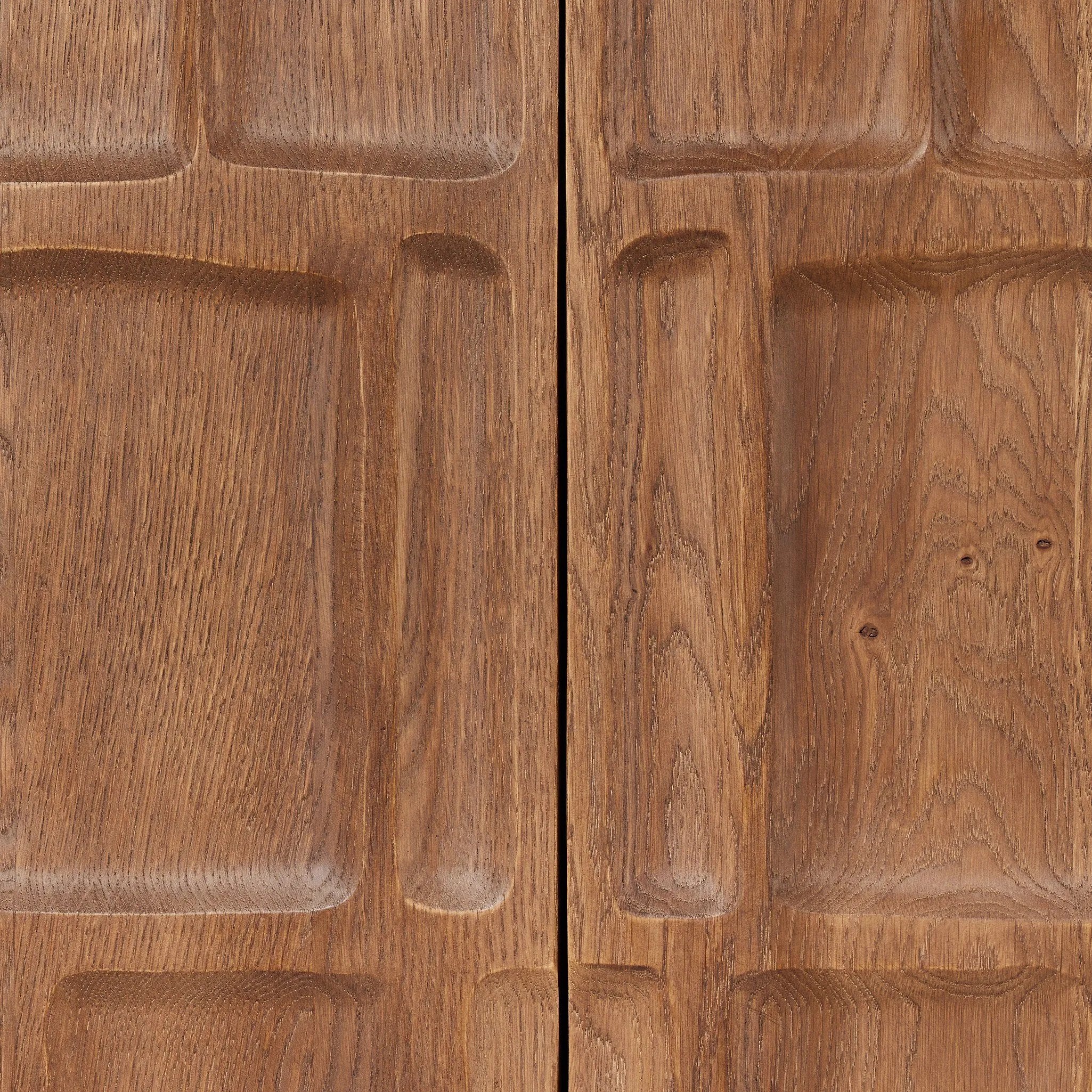 Made from solid oak and finished in a rich cocoa, tall cabinetry is carved with a unique grid-like pattern, for an organic look and textural touch. Interior shelving made from solid mango brings bonus storage to any room. Subtle variations in natural wood graining to be expected Amethyst Home provides interior design, new home construction design consulting, vintage area rugs, and lighting in the Portland metro area.