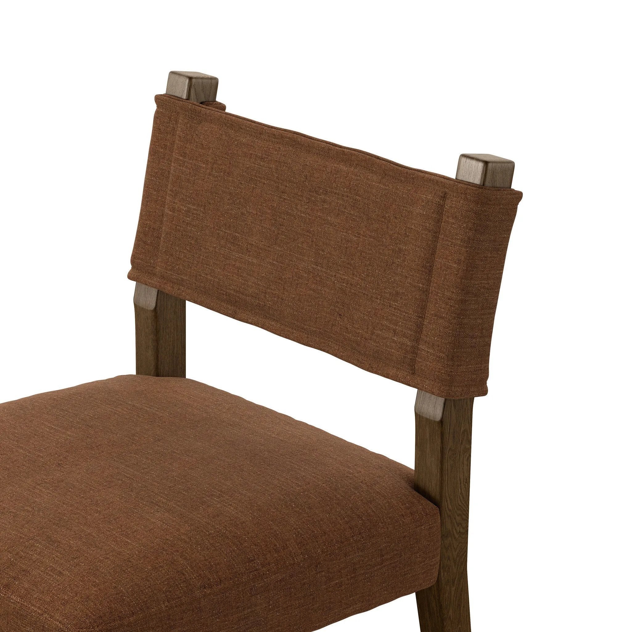 Mixed materials at their finest. Brown parawood forms a slight, simple frame for squared seating of neutral performance-grade upholstery. Charcoal top-grain leather backing takes this modern-minded dining chair to the next level Amethyst Home provides interior design, new home construction design consulting, vintage area rugs, and lighting in the Austin metro area.