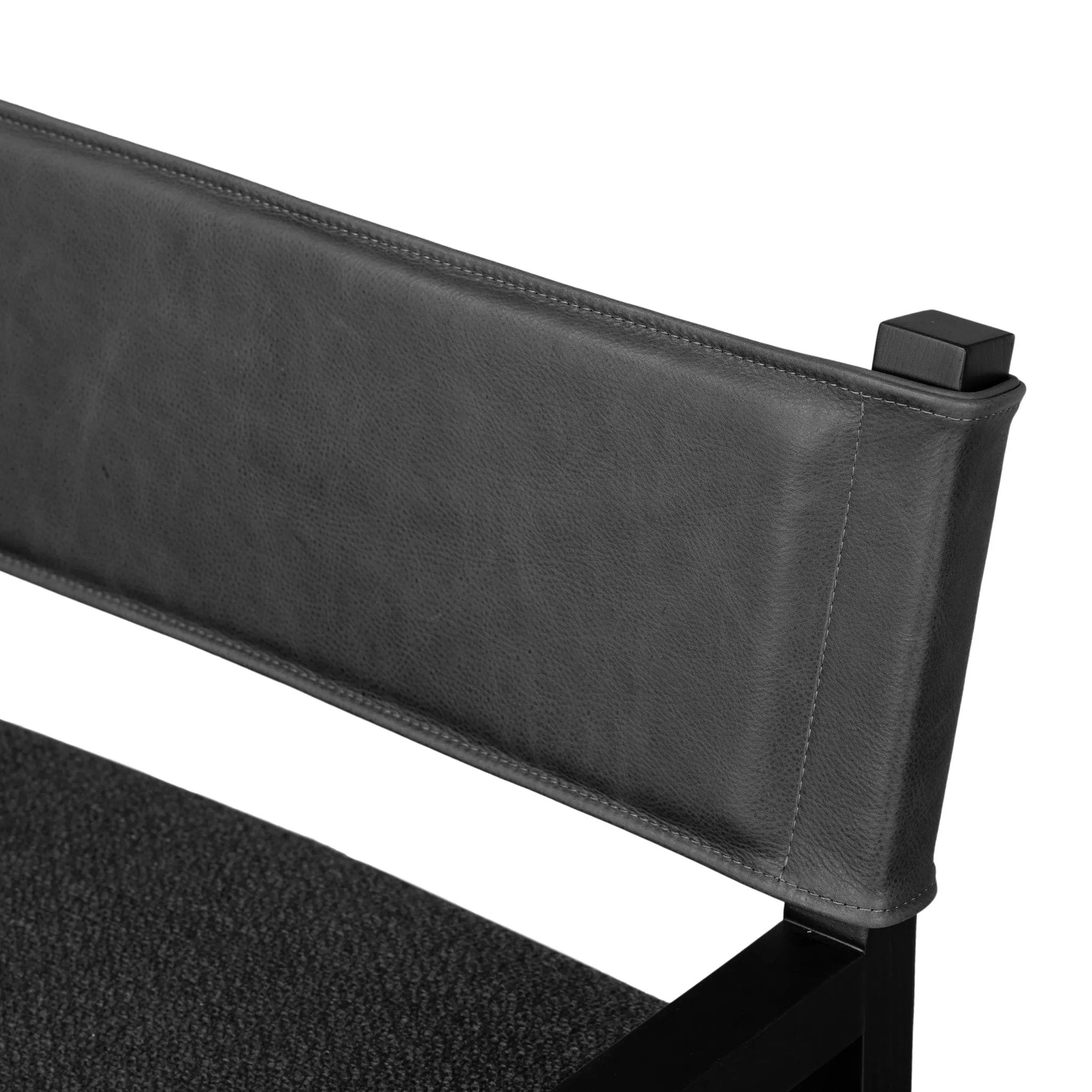 Mixed materials at their finest. Black parawood frames squared seating of high-performance fabric. A top-grain leather back readies this modern-minded armchair for the head of the table. Performance fabrics are specially created to withstand spills, stains, high traffic and wear, ensuring long-term comfort and unmatched durability Amethyst Home provides interior design, new home construction design consulting, vintage area rugs, and lighting in the Charlotte metro area.