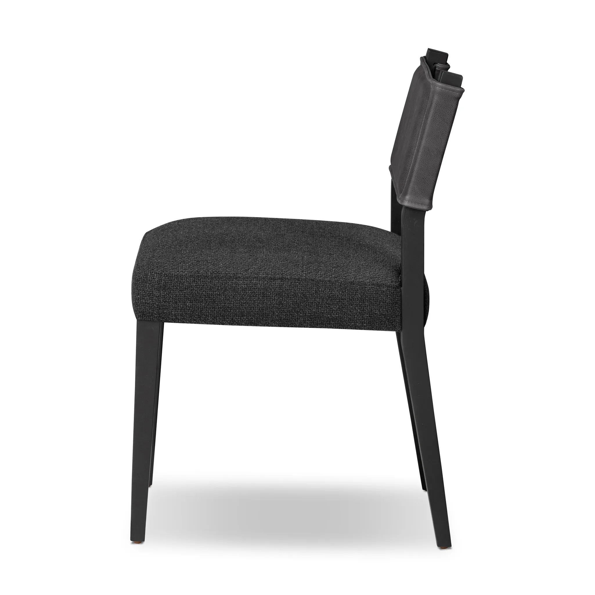 Mixed materials at their finest. Black ash forms a slight, simple frame for squared seating of neutral performance-grade upholstery. Black top-grain leather backing takes this modern-minded dining chair to the next level Amethyst Home provides interior design, new home construction design consulting, vintage area rugs, and lighting in the Houston metro area.