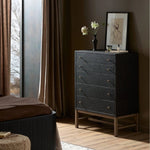 Featuring Fiona Black Raffia Tall Dresser by Four Hands at Amethyst Home. A woven black raffia dresser offers a texture-driven take on bedroom storage. Antique brass-finished hardware adds a touch of vintage detailing, all grounded by a solid mahogany base. Overall Dimensions: 34.00"w x 19.00"d x 47.50"h. Amethyst Home provides interior design, new home construction design consulting, vintage area rugs, and lighting in the Austin metro area.