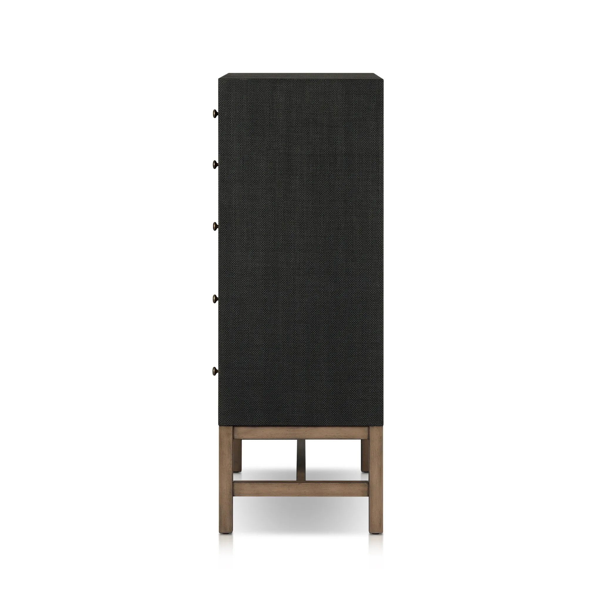 Featuring Fiona Black Raffia Tall Dresser by Four Hands at Amethyst Home. A woven black raffia dresser offers a texture-driven take on bedroom storage. Antique brass-finished hardware adds a touch of vintage detailing, all grounded by a solid mahogany base. Overall Dimensions: 34.00"w x 19.00"d x 47.50"h. Amethyst Home provides interior design, new home construction design consulting, vintage area rugs, and lighting in the Boston metro area.