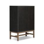 Featuring Fiona Black Raffia Tall Dresser by Four Hands at Amethyst Home. A woven black raffia dresser offers a texture-driven take on bedroom storage. Antique brass-finished hardware adds a touch of vintage detailing, all grounded by a solid mahogany base. Overall Dimensions: 34.00"w x 19.00"d x 47.50"h. Amethyst Home provides interior design, new home construction design consulting, vintage area rugs, and lighting in the Nashville metro area.