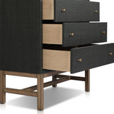 Featuring Fiona Black Raffia Tall Dresser by Four Hands at Amethyst Home. A woven black raffia dresser offers a texture-driven take on bedroom storage. Antique brass-finished hardware adds a touch of vintage detailing, all grounded by a solid mahogany base. Overall Dimensions: 34.00"w x 19.00"d x 47.50"h. Amethyst Home provides interior design, new home construction design consulting, vintage area rugs, and lighting in the Park City metro area.