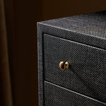 Featuring Fiona Black Raffia Tall Dresser by Four Hands at Amethyst Home. A woven black raffia dresser offers a texture-driven take on bedroom storage. Antique brass-finished hardware adds a touch of vintage detailing, all grounded by a solid mahogany base. Overall Dimensions: 34.00"w x 19.00"d x 47.50"h. Amethyst Home provides interior design, new home construction design consulting, vintage area rugs, and lighting in the Salt Lake City metro area.