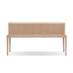 A soft statement console table with ample storage, inspired by a dresser silhouette. The elevated case is wrapped in painted linen and sits atop an oak base for a light and airy look Amethyst Home provides interior design, new home construction design consulting, vintage area rugs, and lighting in the Calabasas metro area.