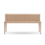 A soft statement console table with ample storage, inspired by a dresser silhouette. The elevated case is wrapped in painted linen and sits atop an oak base for a light and airy look Amethyst Home provides interior design, new home construction design consulting, vintage area rugs, and lighting in the Calabasas metro area.