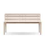 A soft statement console table with ample storage, inspired by a dresser silhouette. The elevated case is wrapped in painted linen and sits atop an oak base for a light and airy look Amethyst Home provides interior design, new home construction design consulting, vintage area rugs, and lighting in the Omaha metro area.