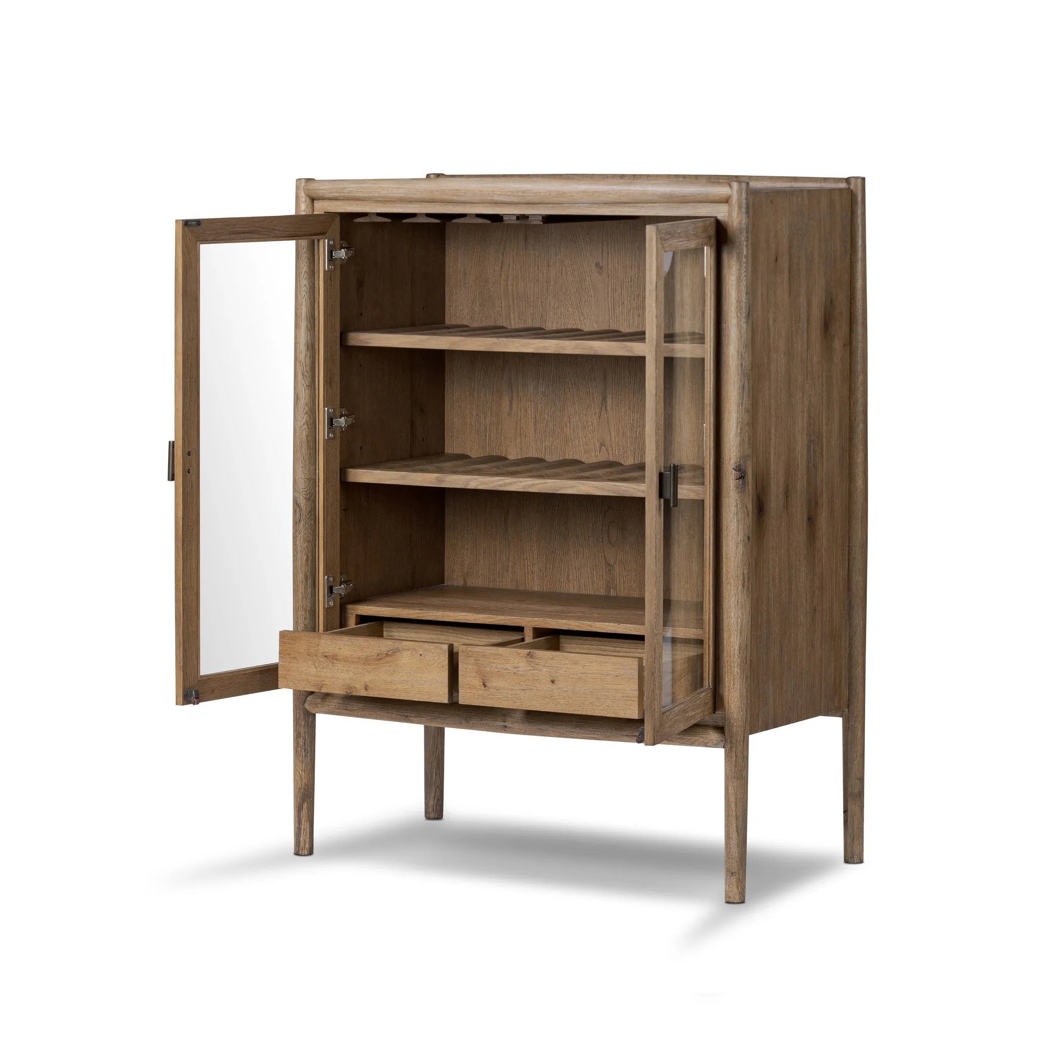 A rustic oak bar cabinet shapes subtly curved corners, bringing a handcrafted look to a minimalist form. Fixed center shelves, functional drawers and glass fronts for open display. Simple hardware is finished in an aged bronze Amethyst Home provides interior design, new home construction design consulting, vintage area rugs, and lighting in the Alpharetta metro area.