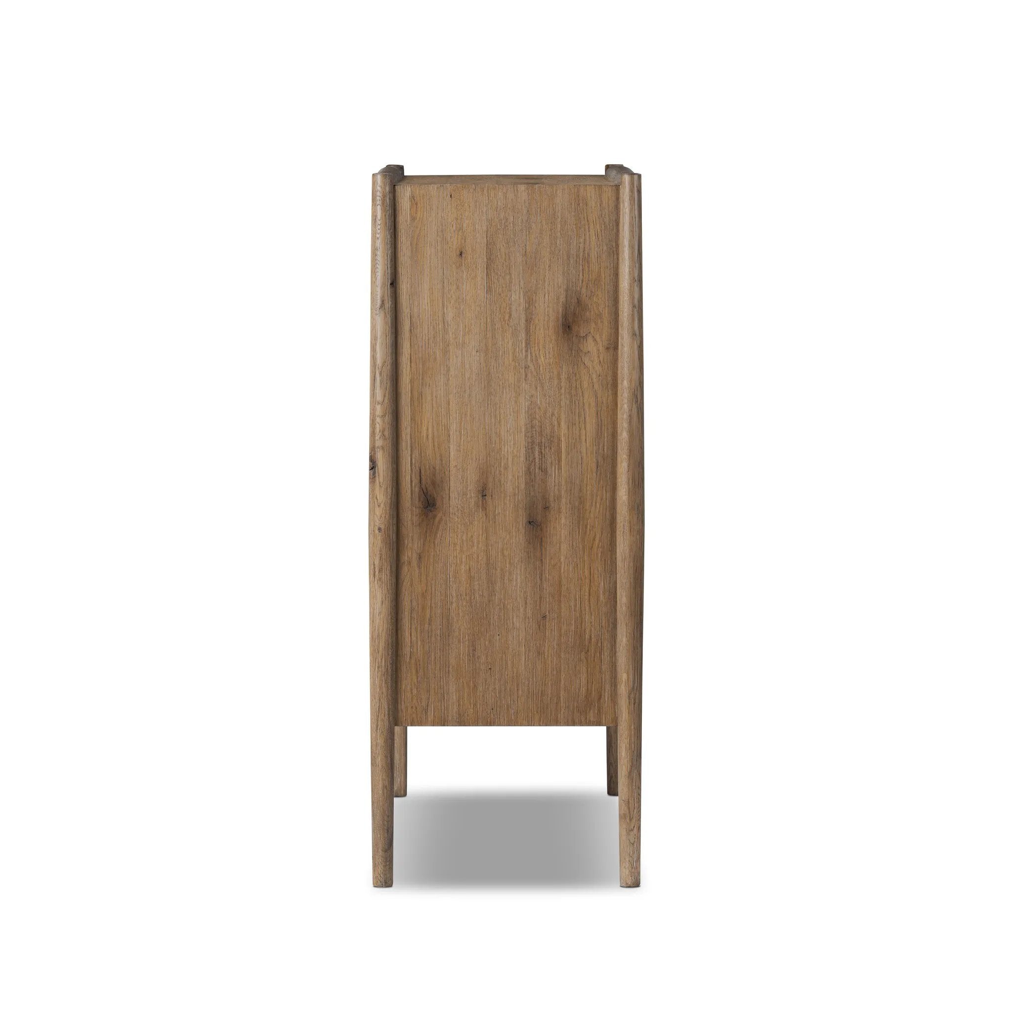 A rustic oak bar cabinet shapes subtly curved corners, bringing a handcrafted look to a minimalist form. Fixed center shelves, functional drawers and glass fronts for open display. Simple hardware is finished in an aged bronze Amethyst Home provides interior design, new home construction design consulting, vintage area rugs, and lighting in the Charlotte metro area.