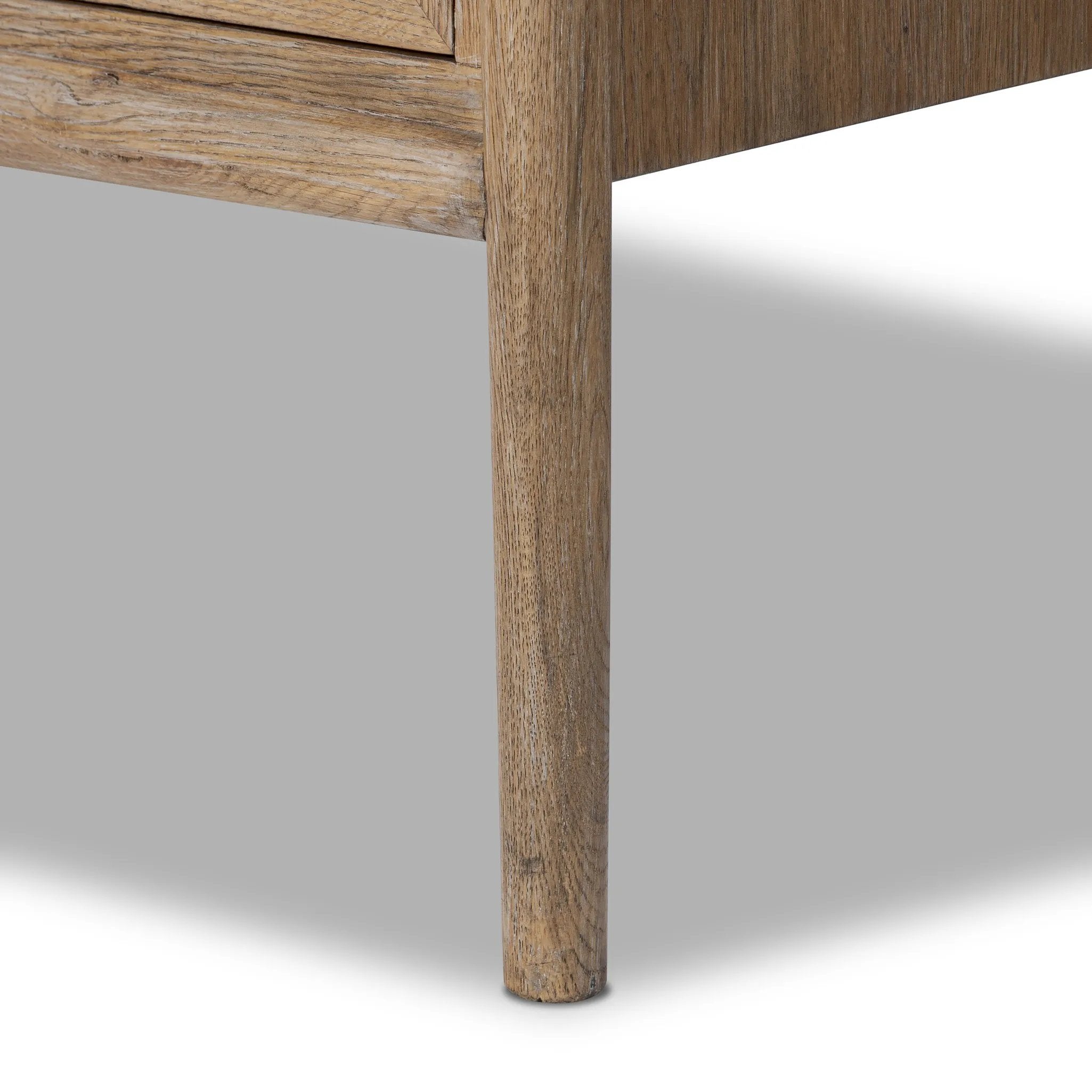 A rustic oak bar cabinet shapes subtly curved corners, bringing a handcrafted look to a minimalist form. Fixed center shelves, functional drawers and glass fronts for open display. Simple hardware is finished in an aged bronze Amethyst Home provides interior design, new home construction design consulting, vintage area rugs, and lighting in the Scottsdale metro area.