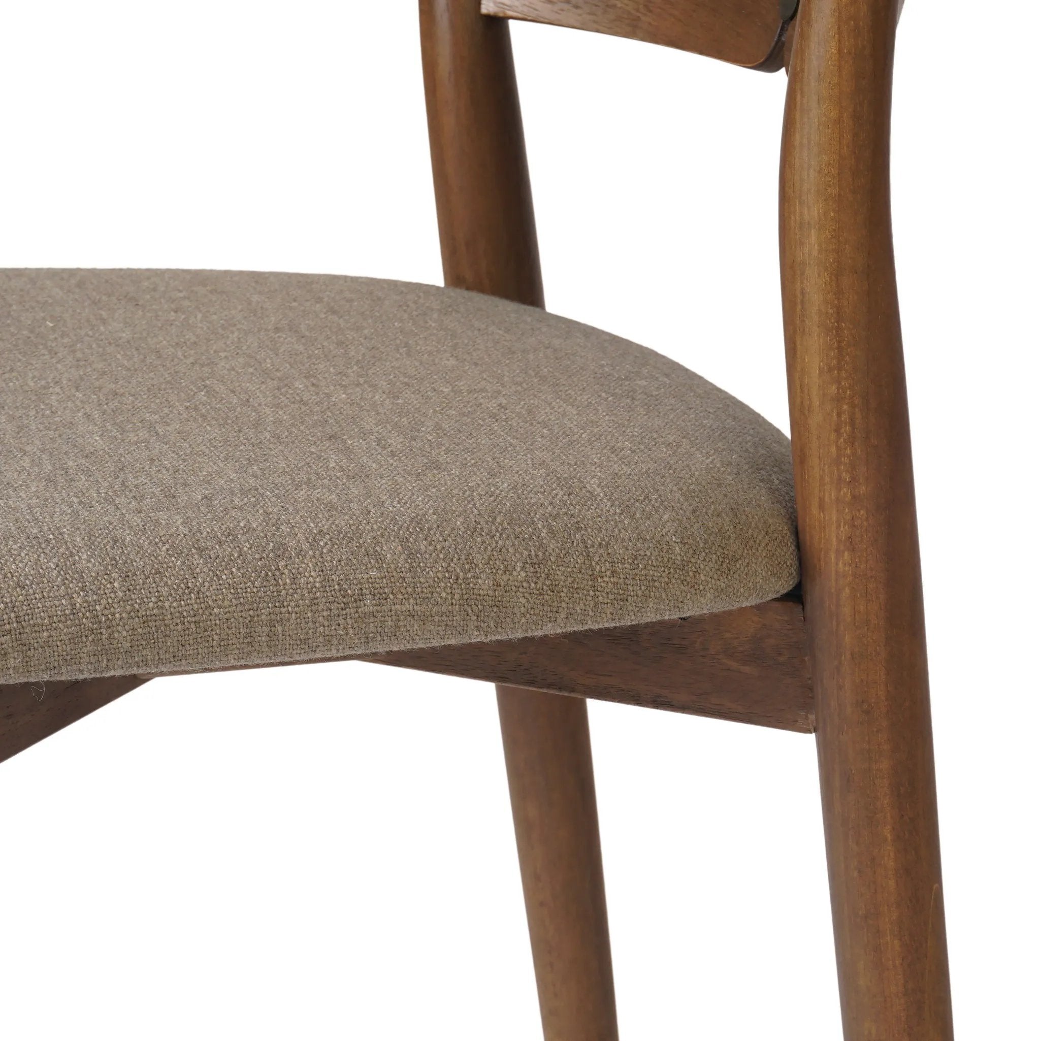 Bring a mixed material moment to your dining space with a Scandinavian-inspired seating style. Solid parawood forms a beautifully curved frame for a slim-profile seat upholstered in taupe high-performance fabric. On the back panel, a thin iron inlay elevates the look with a detail-driven finishing touch. Amethyst Home provides interior design, new home construction design consulting, vintage area rugs, and lighting in the Boston metro area.