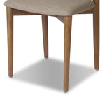 Bring a mixed material moment to your dining space with a Scandinavian-inspired seating style. Solid parawood forms a beautifully curved frame for a slim-profile seat upholstered in taupe high-performance fabric. On the back panel, a thin iron inlay elevates the look with a detail-driven finishing touch. Amethyst Home provides interior design, new home construction design consulting, vintage area rugs, and lighting in the Dallas metro area.