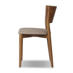 Bring a mixed material moment to your dining space with a Scandinavian-inspired seating style. Solid parawood forms a beautifully curved frame for a slim-profile seat upholstered in taupe high-performance fabric. On the back panel, a thin iron inlay elevates the look with a detail-driven finishing touch. Amethyst Home provides interior design, new home construction design consulting, vintage area rugs, and lighting in the Monterey metro area.