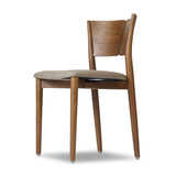 Bring a mixed material moment to your dining space with a Scandinavian-inspired seating style. Solid parawood forms a beautifully curved frame for a slim-profile seat upholstered in taupe high-performance fabric. On the back panel, a thin iron inlay elevates the look with a detail-driven finishing touch. Amethyst Home provides interior design, new home construction design consulting, vintage area rugs, and lighting in the Newport Beach metro area.