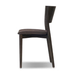 Inspired by simple Scandinavian styling, a dark-finished parawood stool's slit-back metal inlay adds a decorative touch. Easy curves from bent wood give a smooth silhouette. Upholstered with a thin seat cushion upholstered in black performance fabric, perfect for everyday dining. Amethyst Home provides interior design, new home construction design consulting, vintage area rugs, and lighting in the Des Moines metro area.