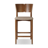 Inspired by simple Scandinavian styling, a tan-finished parawood stool's slit-back metal inlay adds a decorative touch. Easy curves from bent wood give a smooth silhouette. Sized for the counter and upholstered with a thin seat cushion in linen-cotton taupe Amethyst Home provides interior design, new home construction design consulting, vintage area rugs, and lighting in the Dallas metro area.