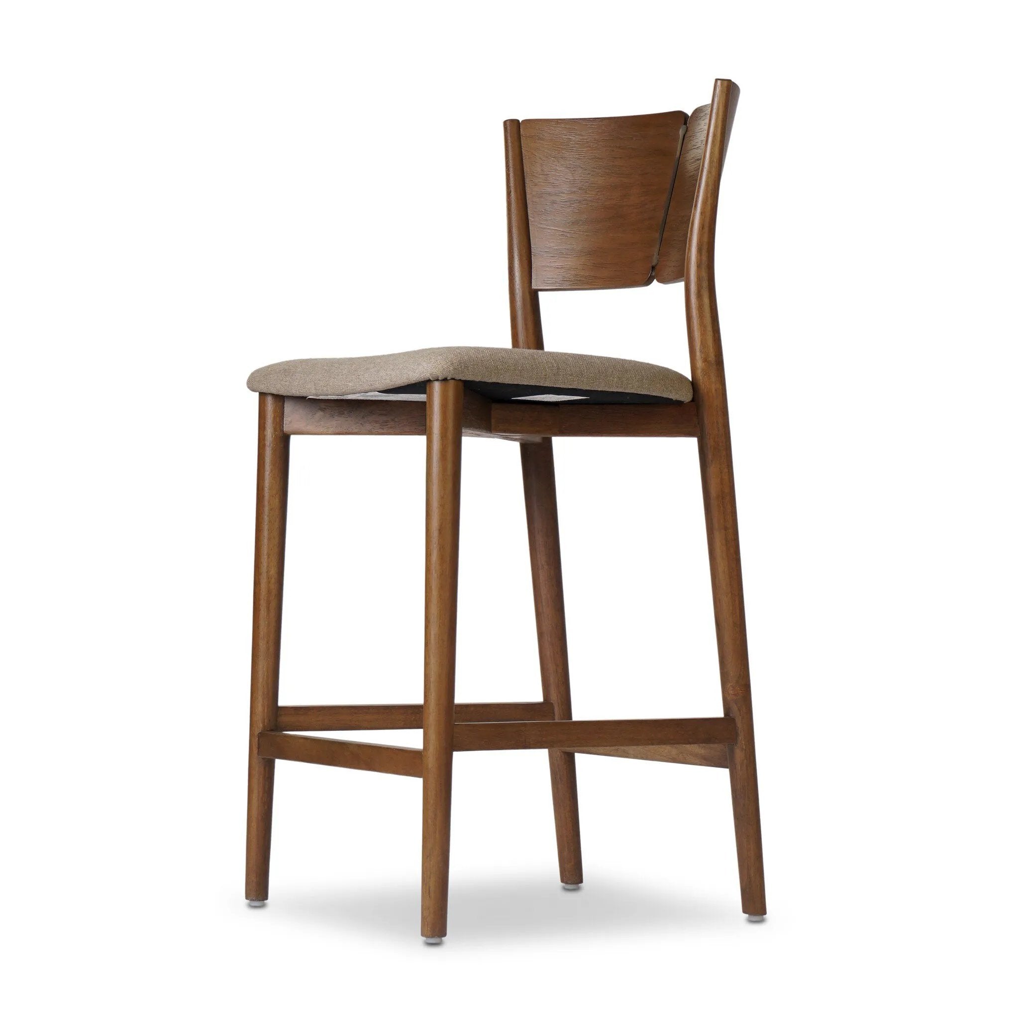 Inspired by simple Scandinavian styling, a tan-finished parawood stool's slit-back metal inlay adds a decorative touch. Easy curves from bent wood give a smooth silhouette. Sized for the counter and upholstered with a thin seat cushion in linen-cotton taupe Amethyst Home provides interior design, new home construction design consulting, vintage area rugs, and lighting in the Los Angeles metro area.
