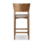 Inspired by simple Scandinavian styling, a tan-finished parawood stool's slit-back metal inlay adds a decorative touch. Easy curves from bent wood give a smooth silhouette. Sized for the counter and upholstered with a thin seat cushion in linen-cotton taupe Amethyst Home provides interior design, new home construction design consulting, vintage area rugs, and lighting in the Salt Lake City metro area.