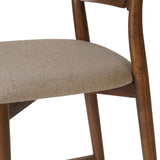 Inspired by simple Scandinavian styling, a tan-finished parawood stool's slit-back metal inlay adds a decorative touch. Easy curves from bent wood give a smooth silhouette. Sized for the counter and upholstered with a thin seat cushion in linen-cotton taupe Amethyst Home provides interior design, new home construction design consulting, vintage area rugs, and lighting in the Washington metro area.
